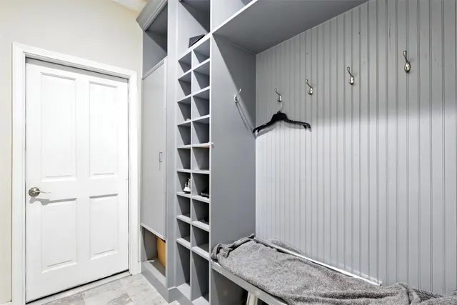 a view of room with walk in closet and wooden floor