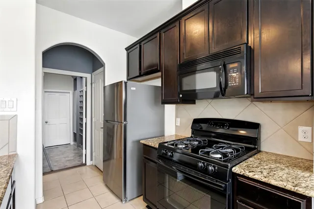 a kitchen with stainless steel appliances granite countertop cabinets and a stove top oven