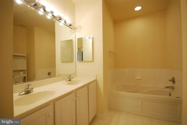 a bathroom with a double vanity sink a mirror and a shower