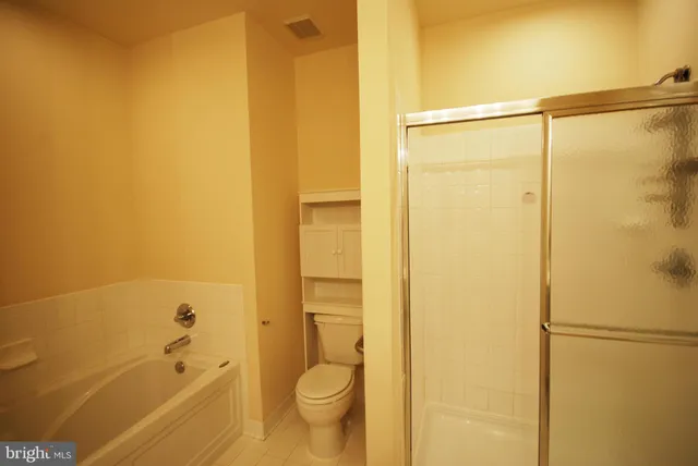 a bathroom with a shower and a toilet