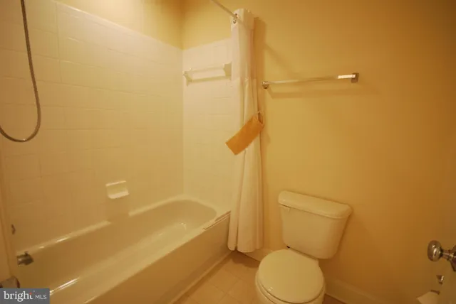 a bathroom with a toilet and a bathtub