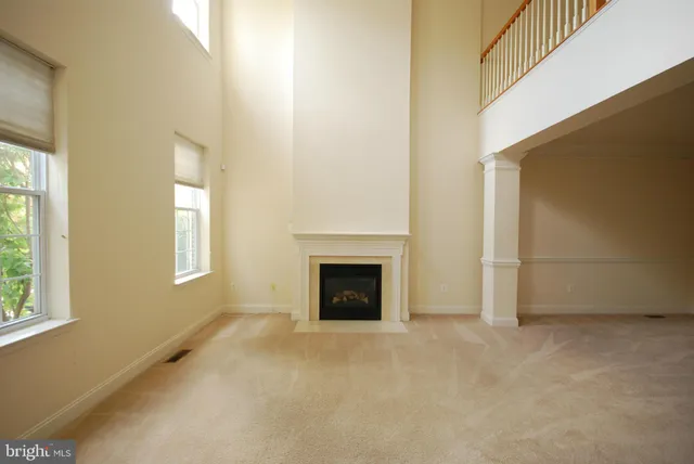 a view of a livingroom with a fireplace and window