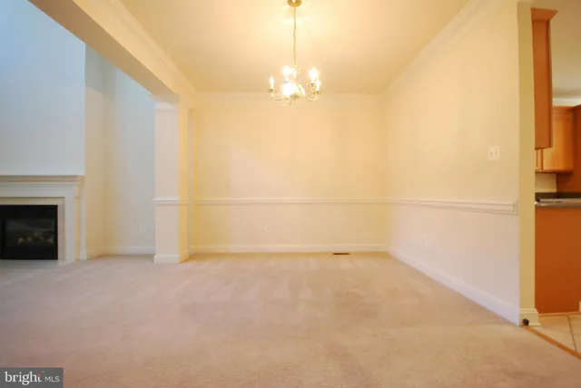 a view of an empty room with a fireplace