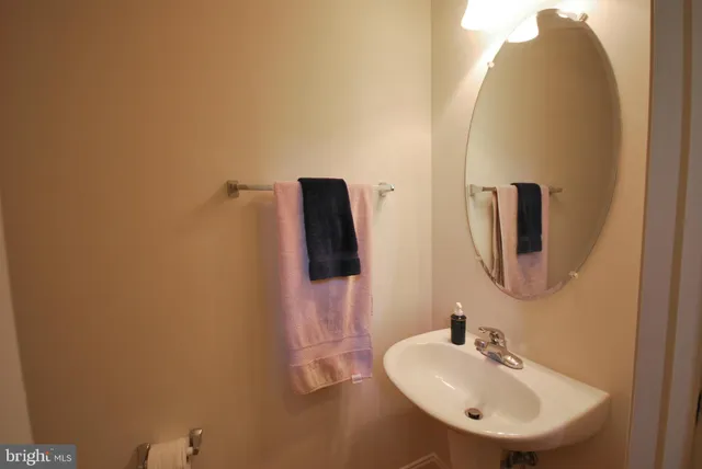 a bathroom with a sink and mirror