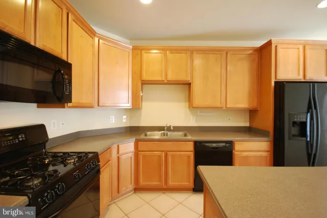 a kitchen with a sink a stove and refrigerator