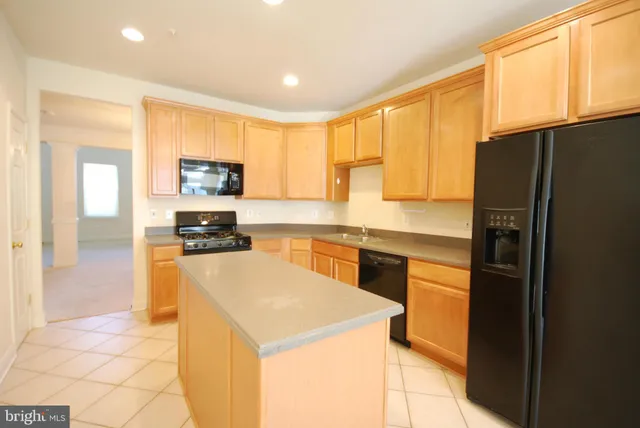a kitchen with stainless steel appliances a refrigerator sink and microwave