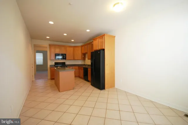 a kitchen with stainless steel appliances a refrigerator and a stove top oven