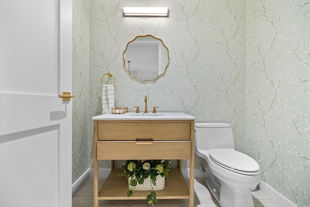 300 Pier 4 Blvd., Unit PHR Boston, MA 02210 - Photo 16 of 28 a bathroom with a toilet a sink and mirror