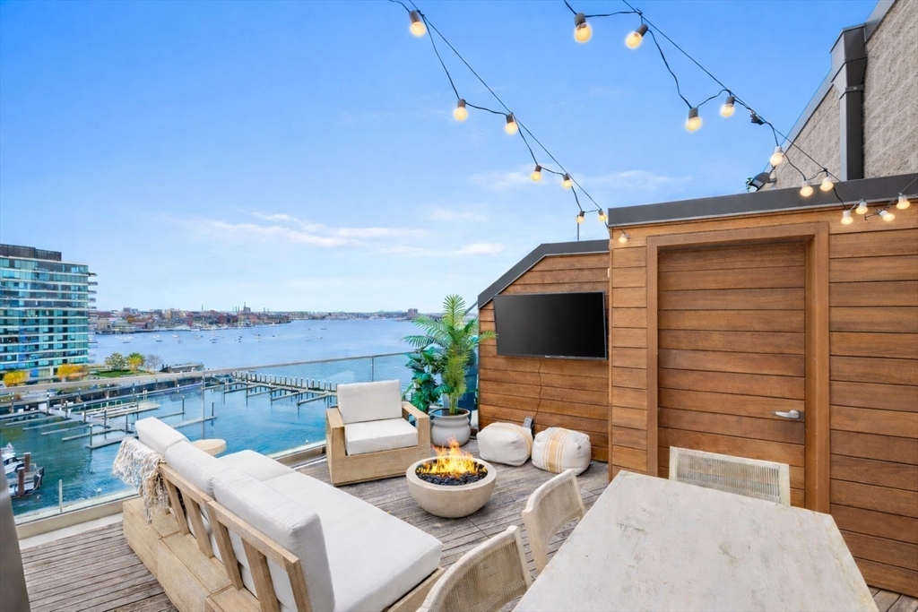 300 Pier 4 Blvd., Unit PHR Boston, MA 02210 - Photo 20 of 28 a view of a balcony with chairs and a potted plant