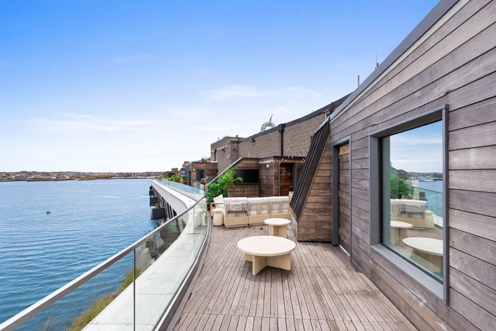 300 Pier 4 Blvd., Unit PHR Boston, MA 02210 - Photo 22 of 28 a view of a balcony with chairs and wooden floor