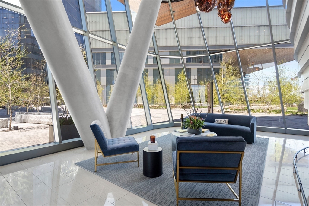 300 Pier 4 Blvd., Unit PHR Boston, MA 02210 - Photo 24 of 28 a living room with furniture and a floor to ceiling window