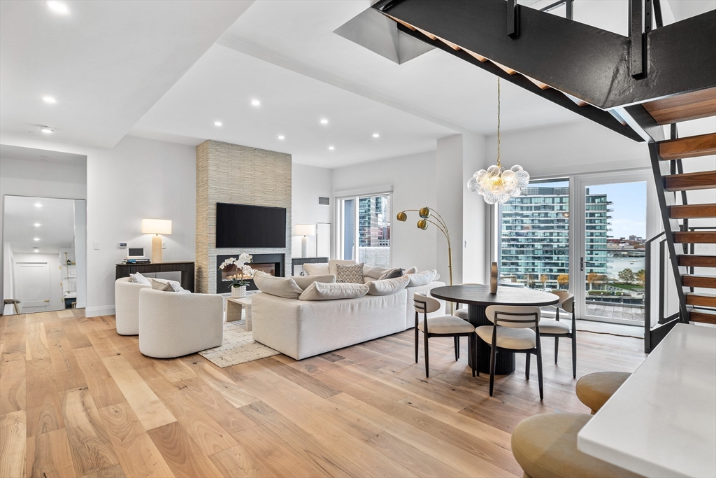 300 Pier 4 Blvd., Unit PHR Boston, MA 02210 - Photo 6 of 28 a living room with furniture and a large window