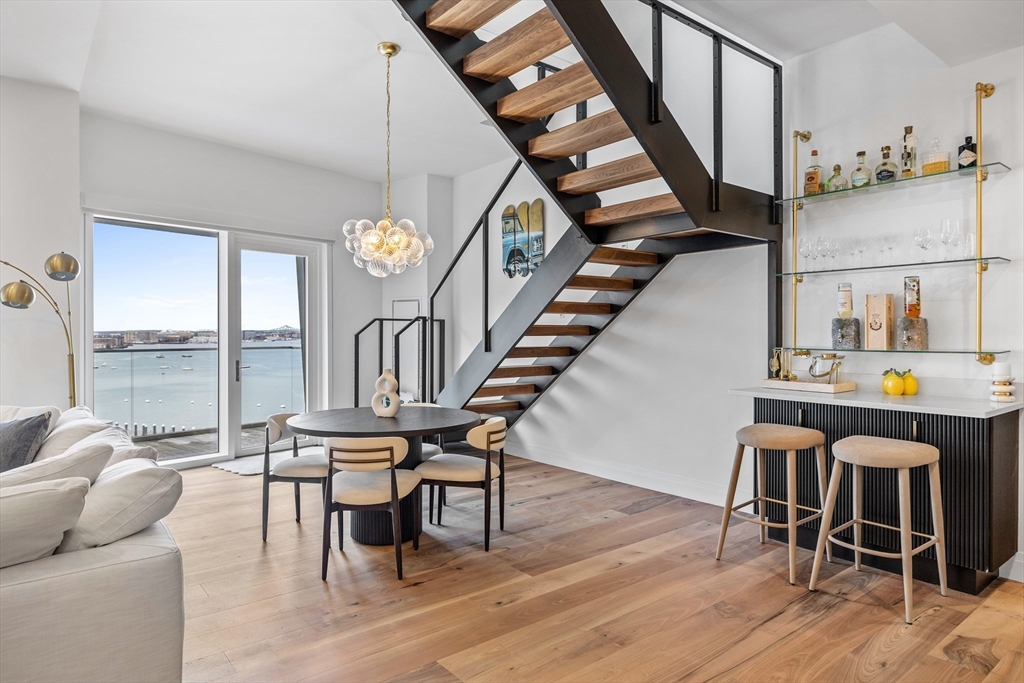 300 Pier 4 Blvd., Unit PHR Boston, MA 02210 - Photo 7 of 28 a dining room with furniture entryway and wooden floor