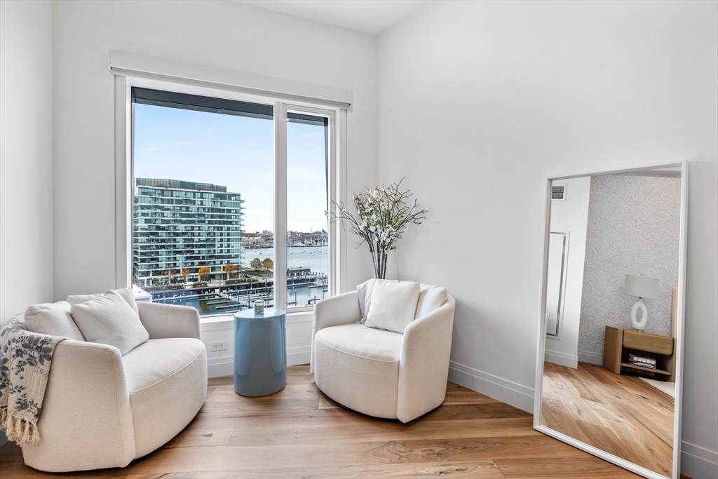 300 Pier 4 Blvd., Unit PHR Boston, MA 02210 - Photo 9 of 28 a living room with furniture and a large window