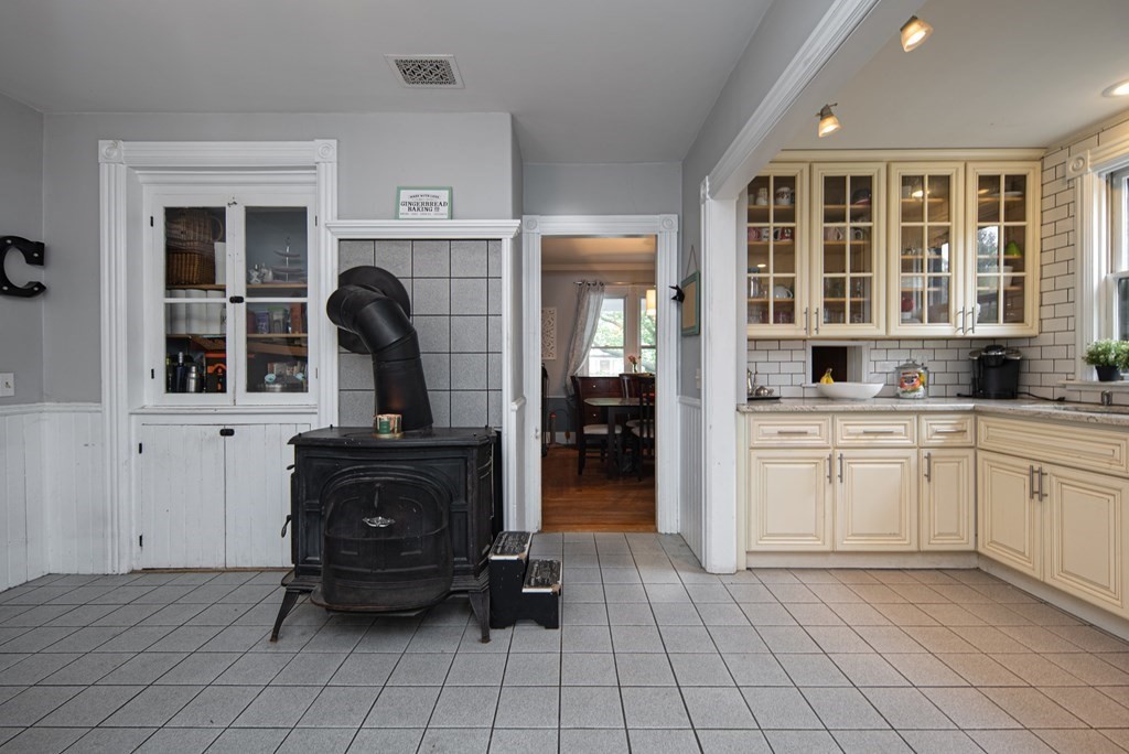 1571 Mendon Road Cumberland, RI 02864 - Photo 13 of 26 a kitchen with a refrigerator and cabinets
