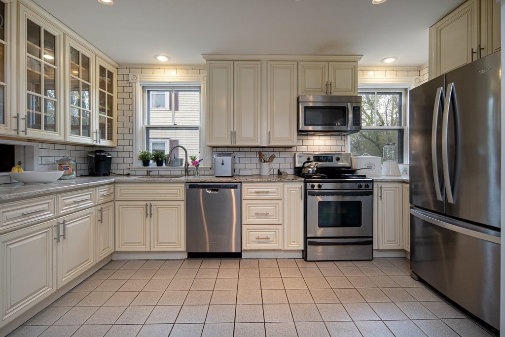 1571 Mendon Road Cumberland, RI 02864 - Photo 16 of 26 a kitchen with a stove a sink and a refrigerator