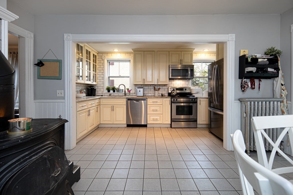 1571 Mendon Road Cumberland, RI 02864 - Photo 17 of 26 a kitchen with a sink a stove and cabinets