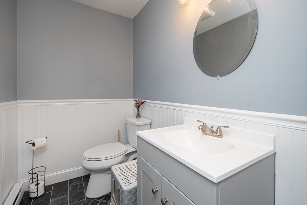 1571 Mendon Road Cumberland, RI 02864 - Photo 19 of 26 a bathroom with a sink a toilet and a mirror