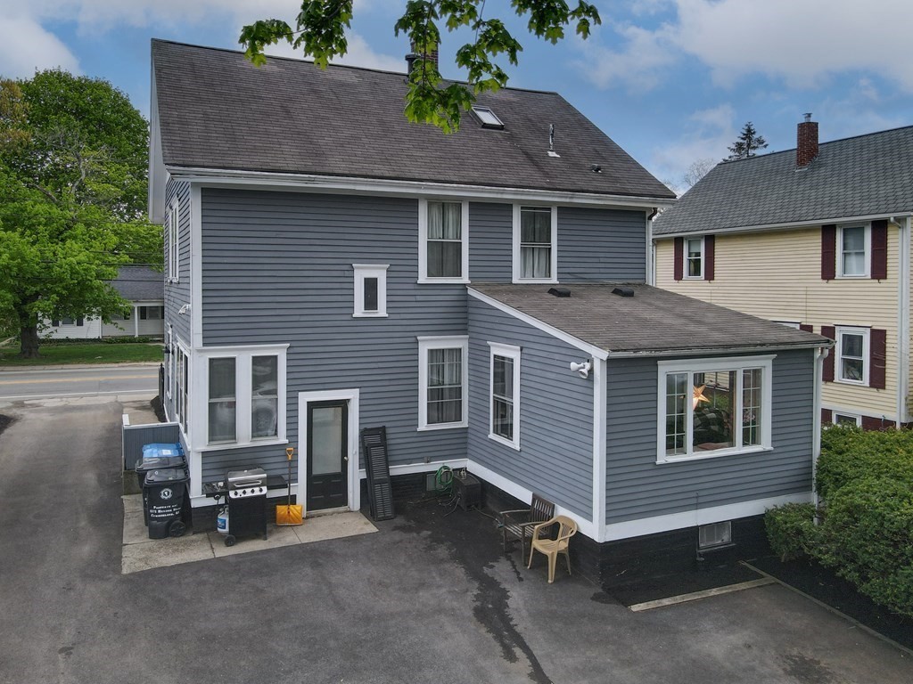 1571 Mendon Road Cumberland, RI 02864 - Photo 4 of 26 a front view of a house with glass windows and yard