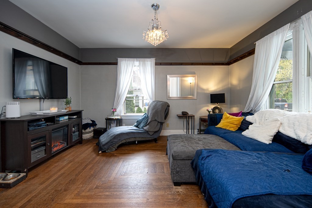 1571 Mendon Road Cumberland, RI 02864 - Photo 8 of 26 a living room with furniture fireplace and a flat screen tv