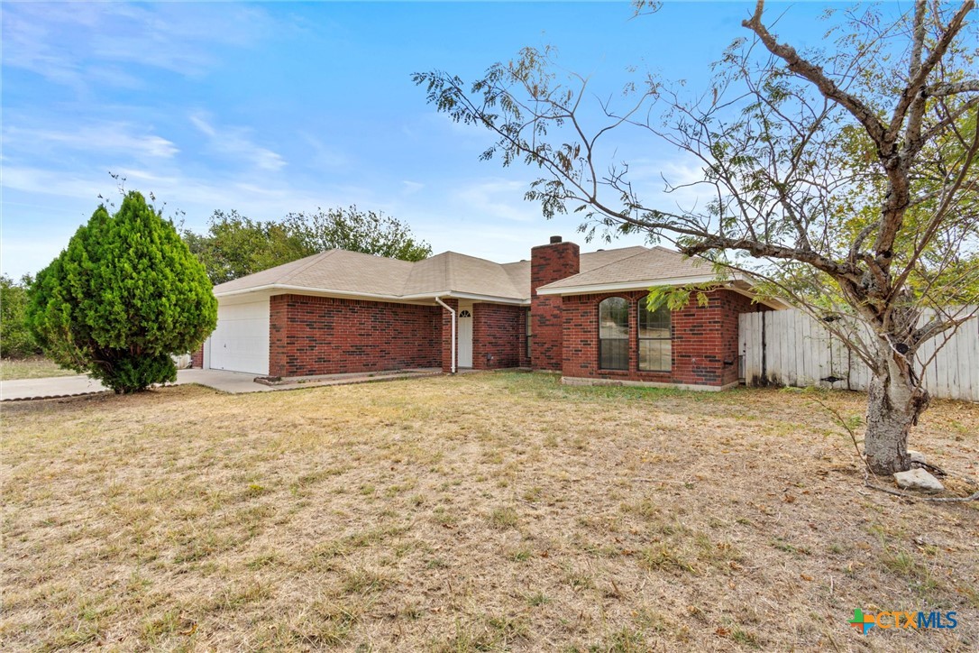 180 County Road 4933 Kempner, TX 76539 - Photo 2 of 24 a front view of a house with a yard and garage