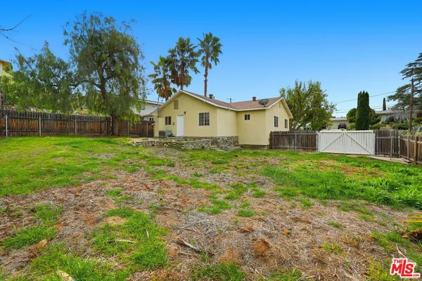 a view of a house with a yard and a garden