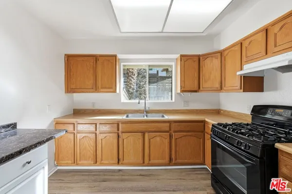 a kitchen with stainless steel appliances granite countertop a stove and a sink