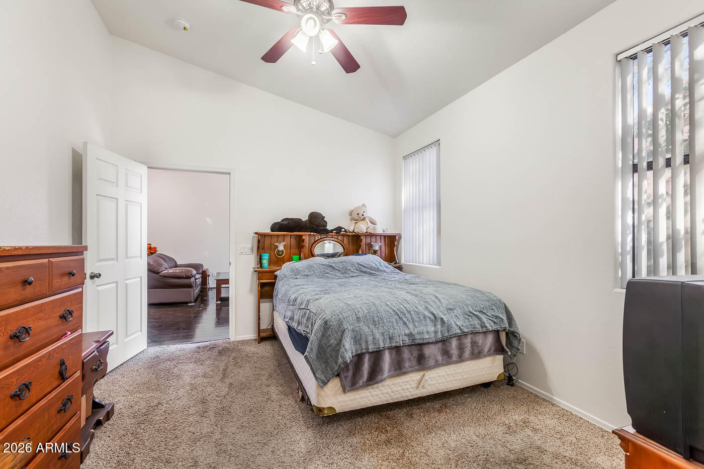 1425 South Lindsay Road, Unit 59 Mesa, AZ 85204 - Photo 13 of 23 a bedroom with a bed and a chandelier