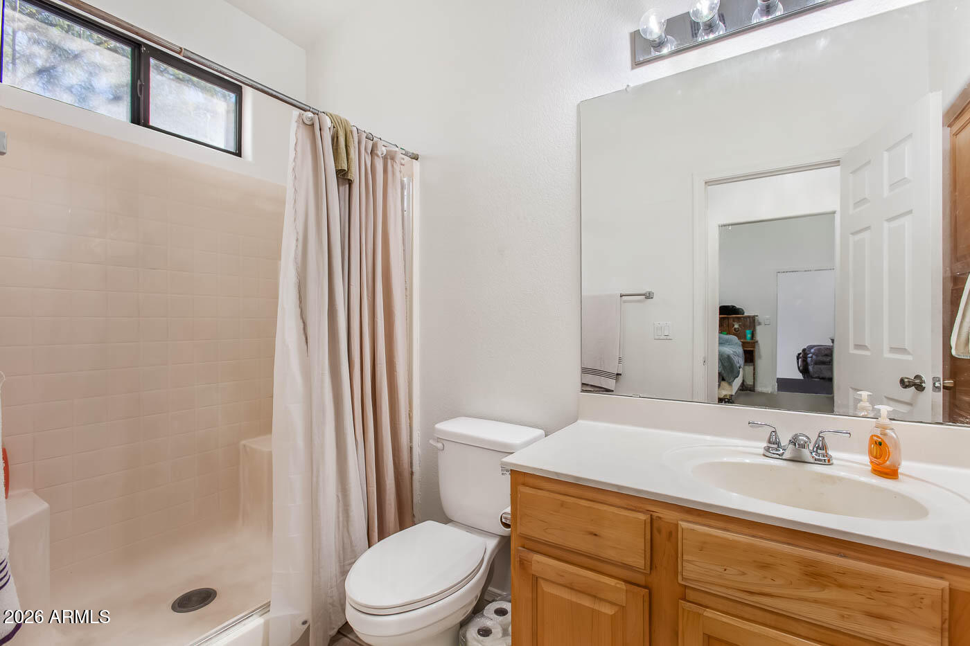 1425 South Lindsay Road, Unit 59 Mesa, AZ 85204 - Photo 15 of 23 a bathroom with a sink a toilet and shower