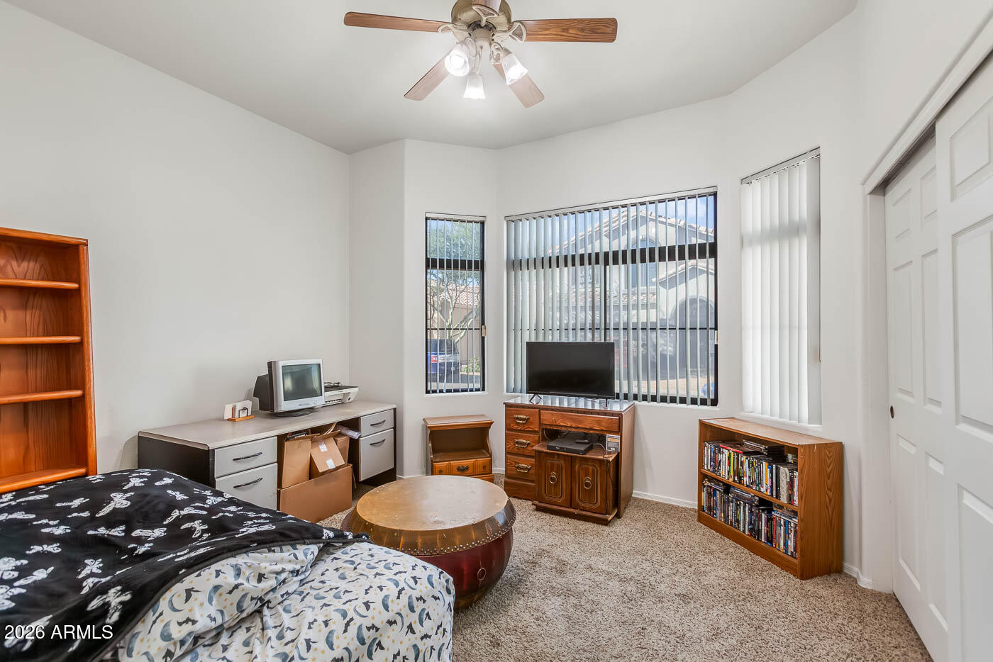 1425 South Lindsay Road, Unit 59 Mesa, AZ 85204 - Photo 17 of 23 a bedroom with a bed and a flat screen tv