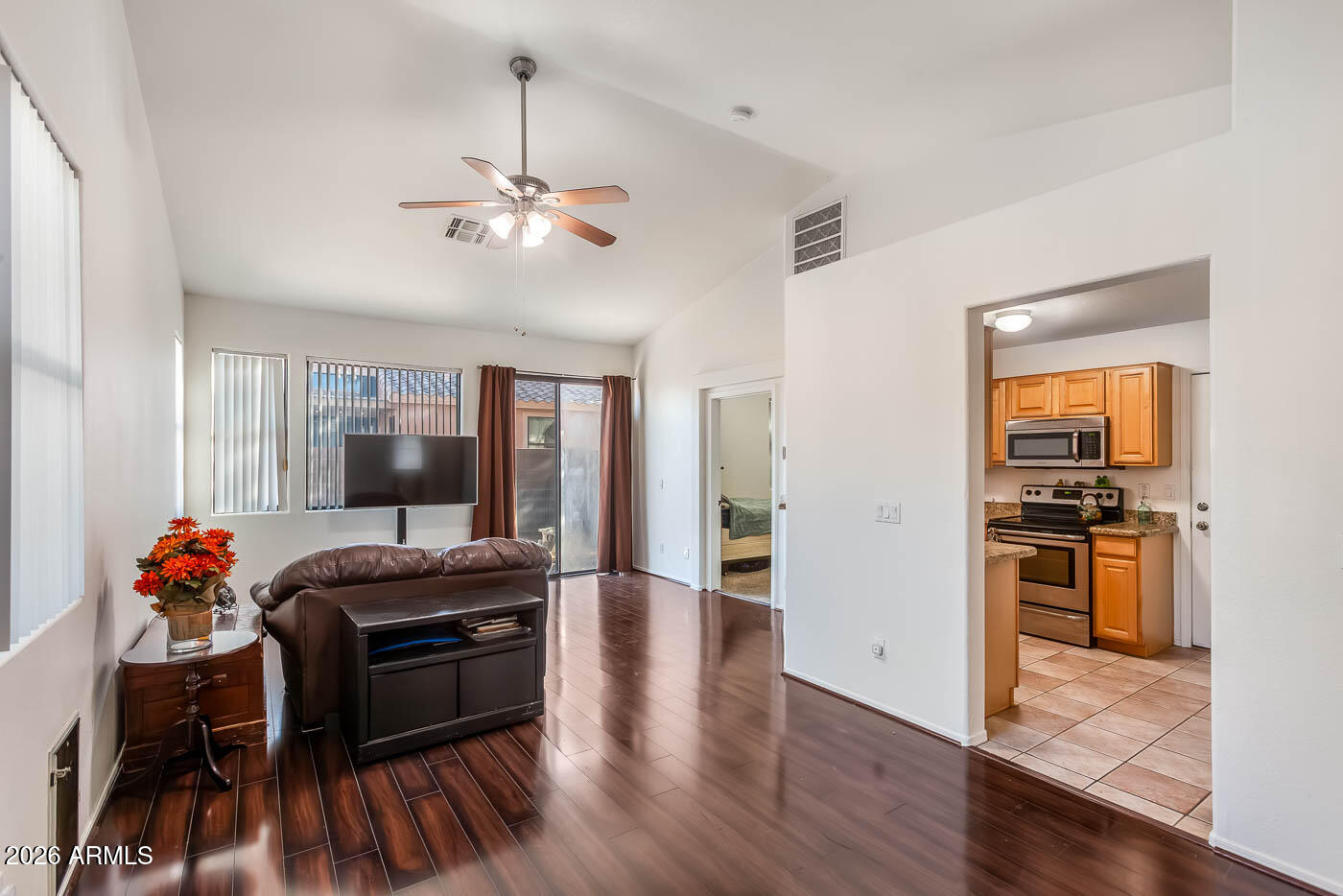 1425 South Lindsay Road, Unit 59 Mesa, AZ 85204 - Photo 2 of 23 a living room with furniture flat screen tv and wooden floor