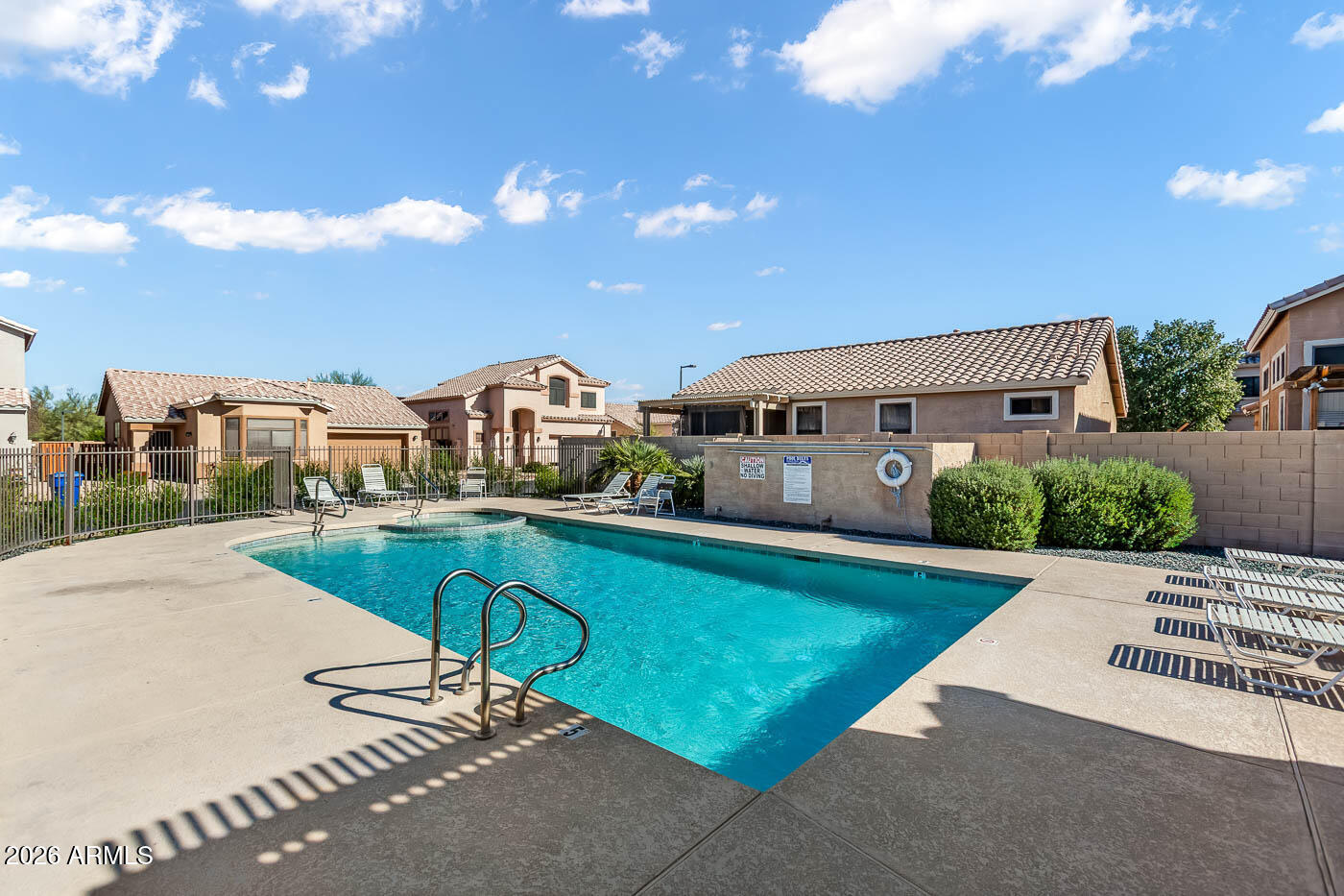 1425 South Lindsay Road, Unit 59 Mesa, AZ 85204 - Photo 9 of 23 a swimming pool with outdoor seating and yard