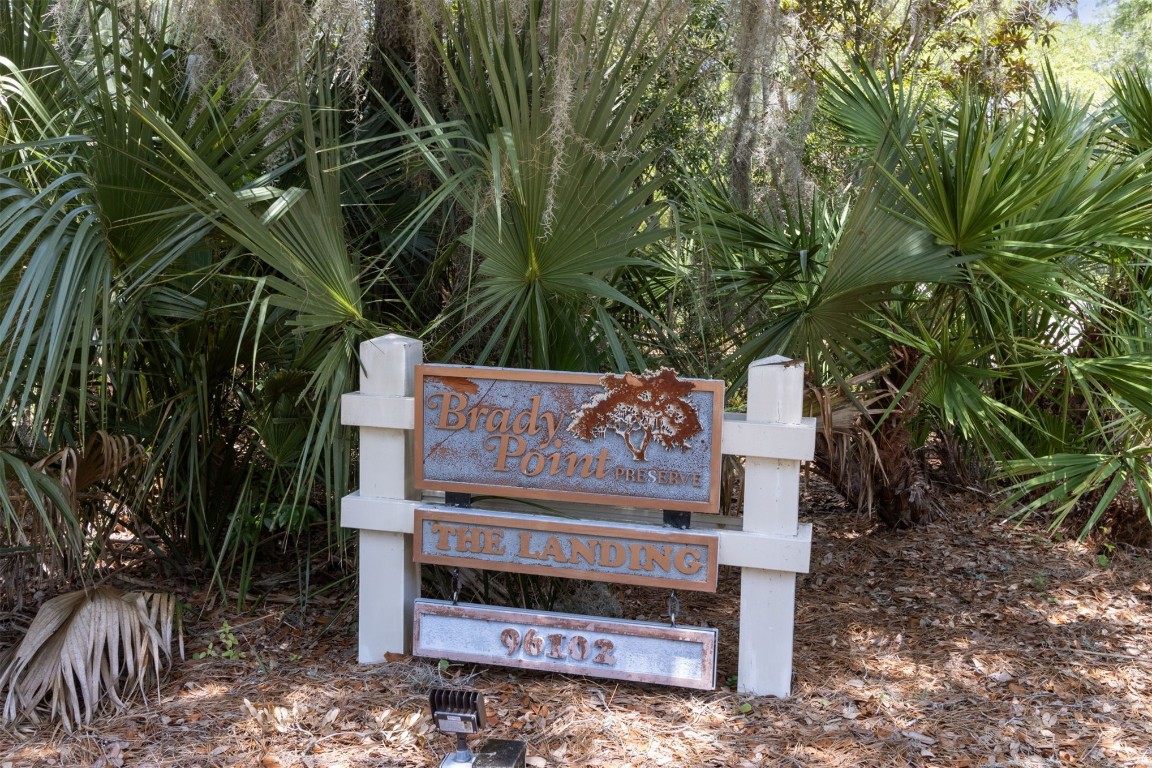 95164 Shell Midden Lane Fernandina Beach, FL 32034 - Photo 15 of 28 a view of a wooden bench sitting in a backyard