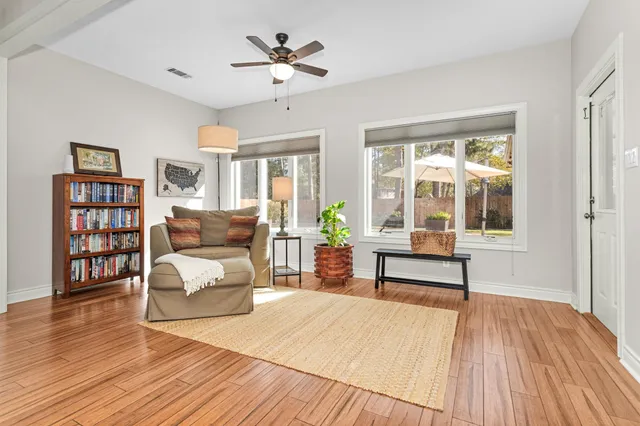 a living room with furniture and a wooden floor
