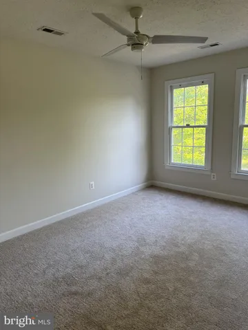 a view of a kitchen with a sink and a refrigerator