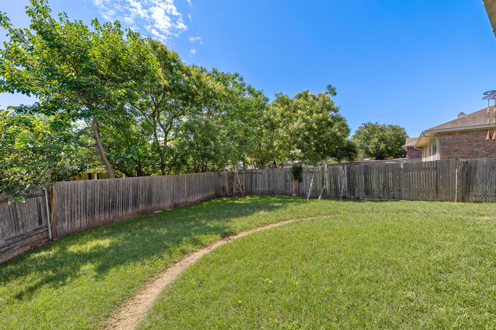 615 Runners Ridge Pflugerville, TX 78660 - Photo 28 of 32 a view of a yard with a fence and trees