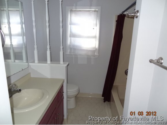 204 Renton Court Fayetteville, NC 28311 - Photo 16 of 25 a bathroom with a granite countertop sink toilet and shower