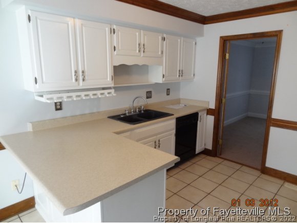 204 Renton Court Fayetteville, NC 28311 - Photo 17 of 25 a kitchen with a sink and cabinets
