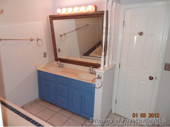 204 Renton Court Fayetteville, NC 28311 - Photo 23 of 25 a bathroom with a mirror and a sink
