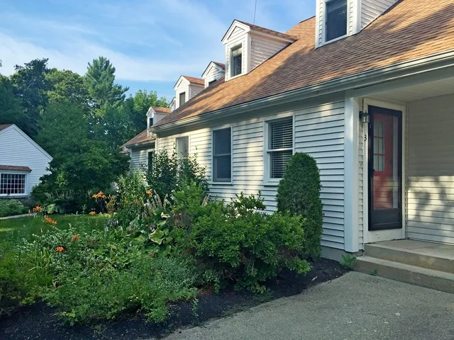 a yellow house with trees in front of it