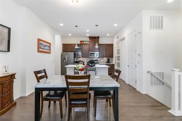 a dining room with kitchen island a dining table and chairs