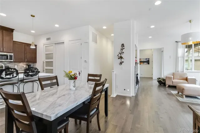 a view of a dining room with furniture and wooden floor
