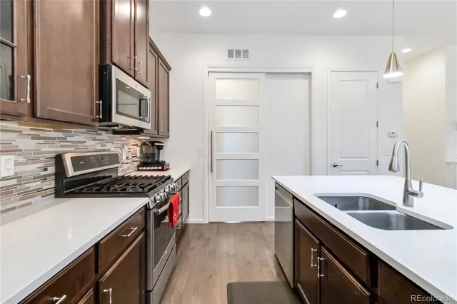a kitchen that has a sink and a stove