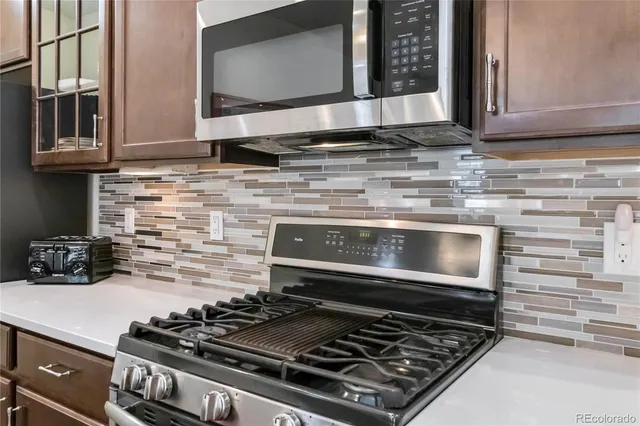 a stove top oven sitting inside of a kitchen