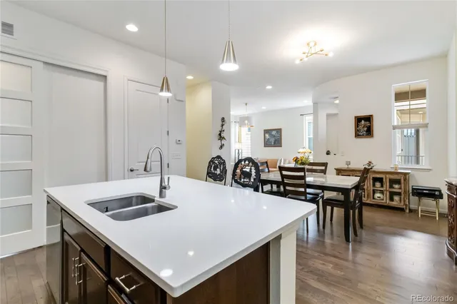 a large kitchen with kitchen island a sink table and chairs