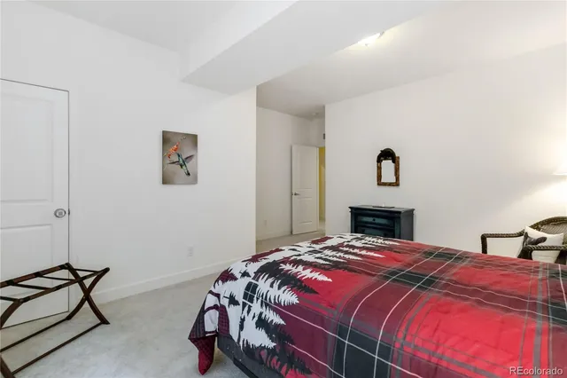 a bedroom with a bed and a potted plant