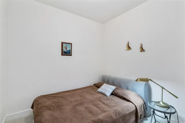 a bedroom with a bed and chair