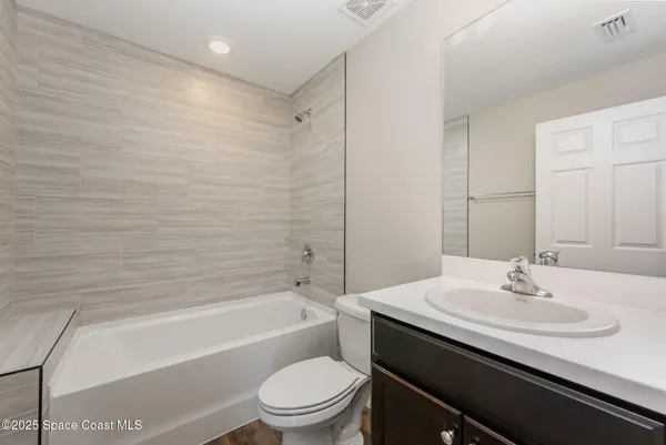 a bathroom with a sink a toilet and bathtub