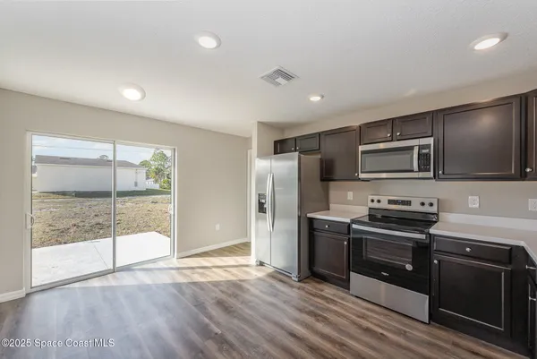 a kitchen with stainless steel appliances granite countertop a stove and a refrigerator