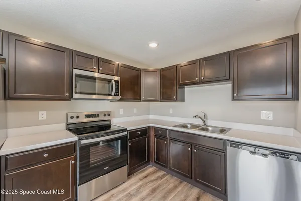a kitchen with a sink and stove top oven